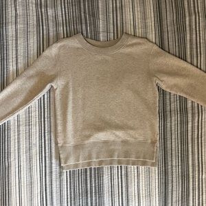 small beige sweatshirt with small pink stain on front